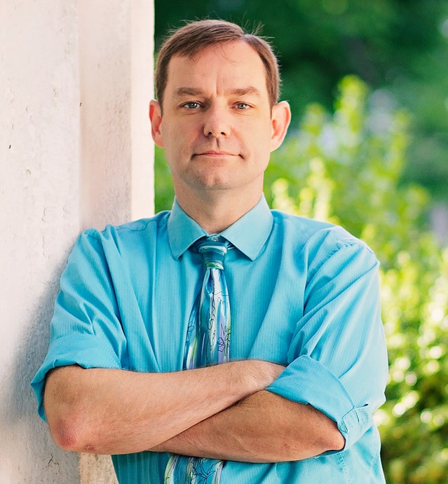 Brian McDonald leans against a building